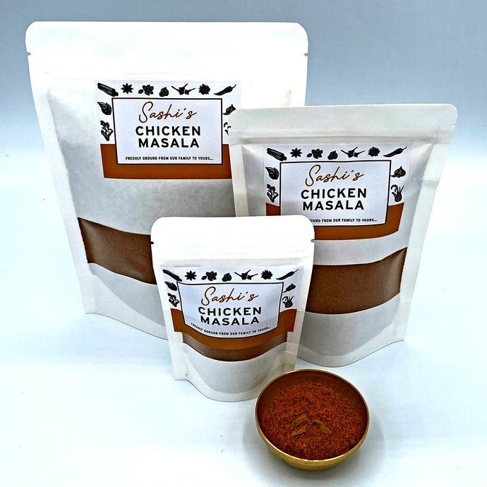 Image of Sashi's Chicken Masala in 3 packet sizes of 50g, 150g, and 200g. With some masala in a gold coloured metal bowl