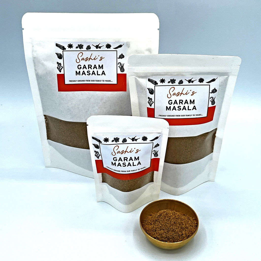 Image of Sashi's Garam Masala in 3 packet sizes of 50g, 150g, and 200g. With some masala in a gold coloured metal bowl